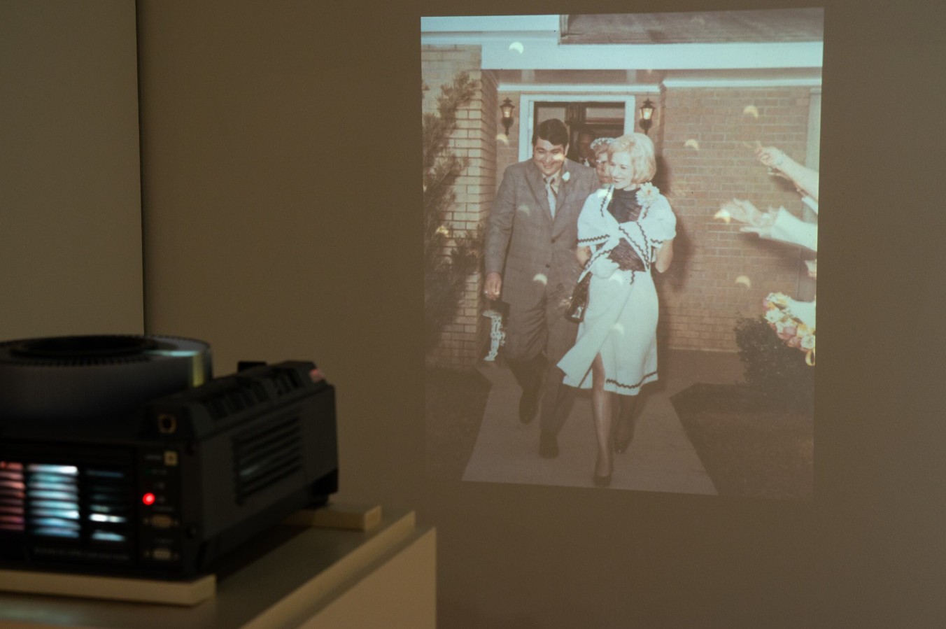 Ashley Gates (born 1981), Diamond Ring, 2024; Installation view; 35mm slides, Kodak Ektapro 9000 slide projector, framed Fuji FP-100c instant photograph