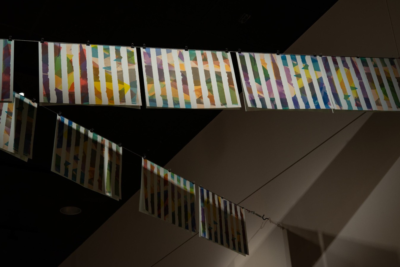 Connor Frew (born 1995), Poem for Daniel Buren (Flags), 2024; Installation view; 18 twelve-color risograph prints on paper, steel cable, binder clips