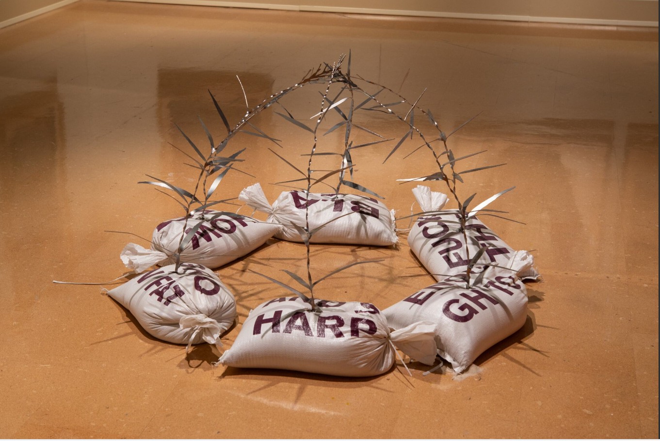 Connor Frew (born 1995), Garden Pavilion (Cutgrass), 2025; Installation view; Sandbags, laser-cut steel, screenprints