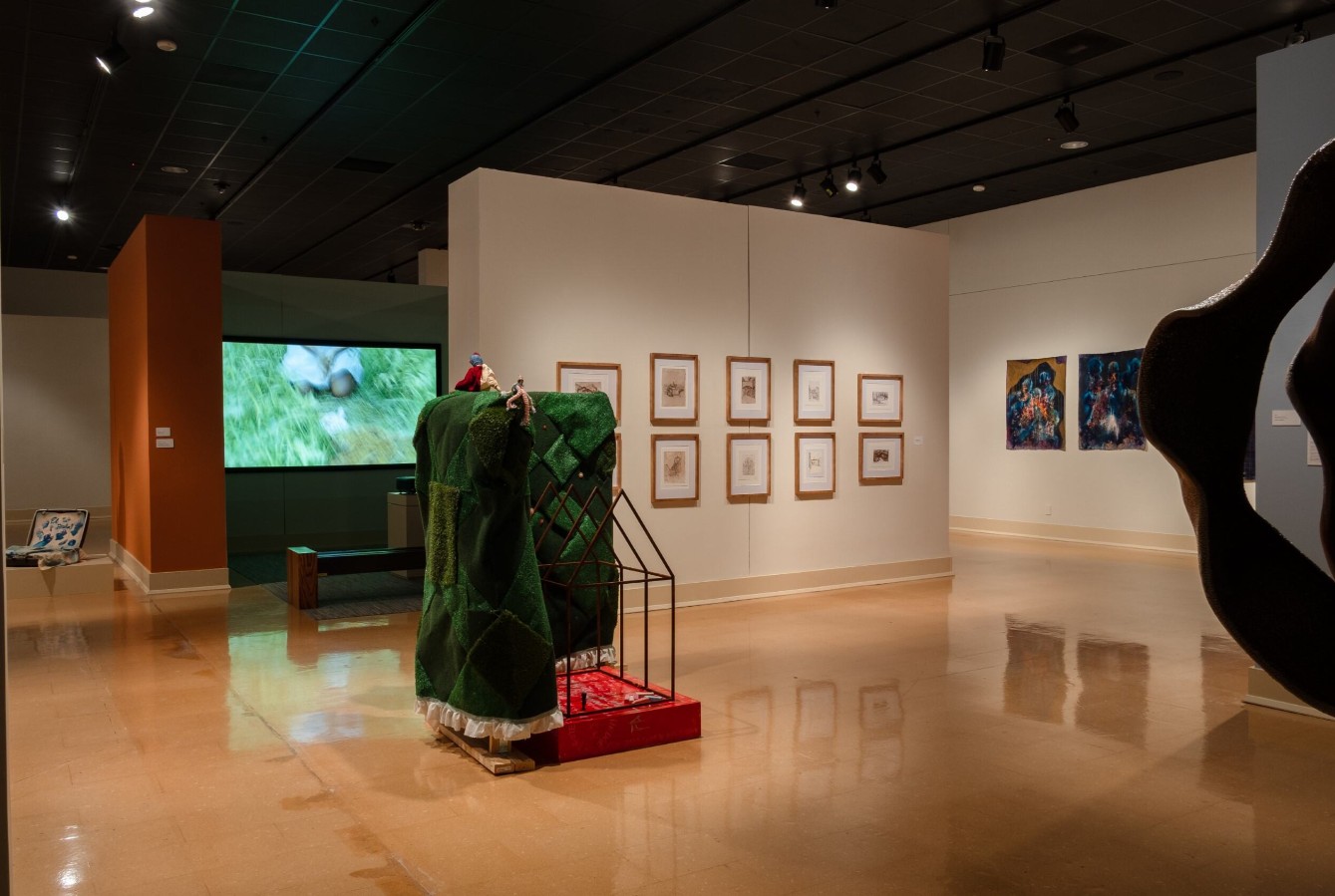 Rylee Brabham (born 2001), Hedge of Protection, 2025; Installation view; Steel, plywood, two-by-fours, AstroTurf, the artist’s great-great grandmother’s quilt blocks, batting, thread, lace, red paint, bronze cast of Mr. Baby